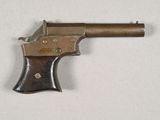 an old gun that is on a white surface