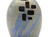a small vase with a blue and black design on it