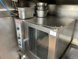 a silver microwave sitting on top of a counter in a kitchen