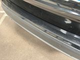 a close up of a car ' s bumper with a sticker on it