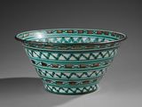 an image of a green and brown bowl sitting on top of a table