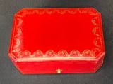 a small red box with gold decorations on it
