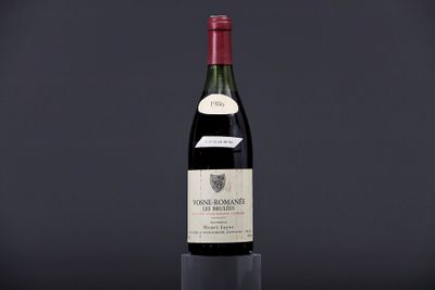 a bottle of wine on a table with a black background