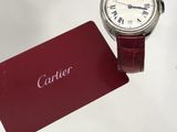 a watch that is sitting next to a card on a table