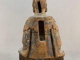 statue of a man with a dog on his back sitting on a stool