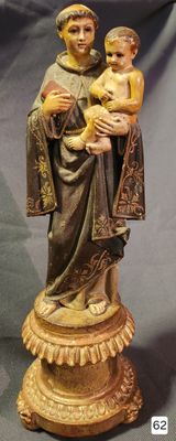 a statue of a woman holding a child on a pedestal