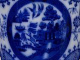 a blue and white vase sitting on a table