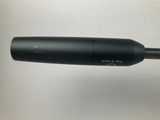 a close up of a microphone on a table with a white background