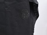 the back of a black skirt with a black logo on it