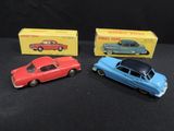 three toy cars are sitting next to each other on a black surface