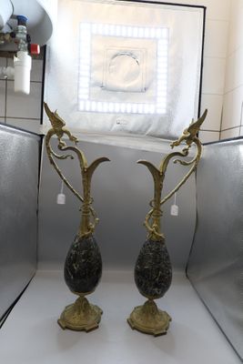 two vases that are sitting on a white table