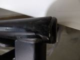 a black pipe sticking out of the side of a white wall