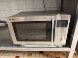a microwave that is sitting on a table in the kitchen