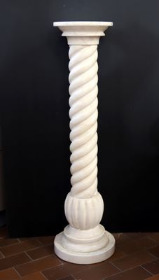 un grand pilier blanc orné d'un motif en spirale