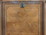 an antique wooden cabinet with a marble top
