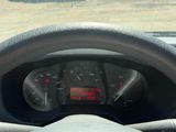 steering wheel of a vehicle with a view of a parking lot in the background