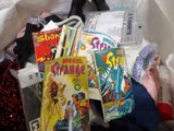 a person holding a book in a bag full of books
