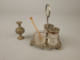 a silver tray with a toothbrush holder and a glass jar