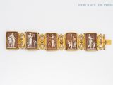 an image of a gold bracelet with a picture of a woman and a man