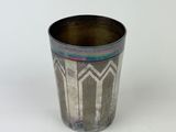 an image of a metal cup with a pattern on it