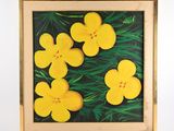 tableau représentant des fleurs jaunes, encadré dans un cadre en bois, accroché à un mur blanc