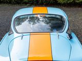a blue and orange car parked on the side of the road