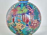 a colorful vase with a gold rim on a white background