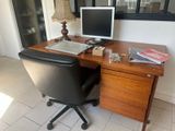 a desk with a computer and a monitor on it