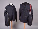 pair of military uniforms on mannequins on display against a gray background