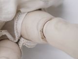 a close up of a doll ' s hand holding a doll ' s hand
