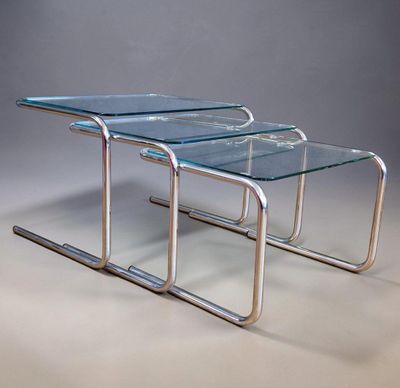 two glass nesting tables with chrome legs and a clear glass top