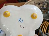 a person holding a white heart shaped object in their hand