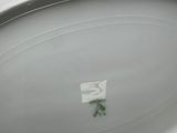 a person holding a white bowl with a sticker on it