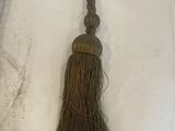 pair of antique tassels with wooden beads on a white background