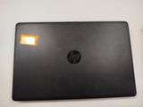 hp laptop with a yellow sticker sitting on top of it