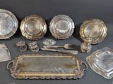 a lot of silver plate and silverware on a table