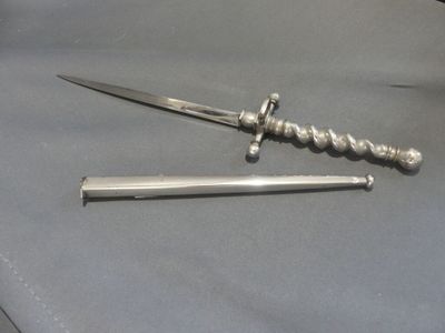 a knife that is laying on a table next to a knife