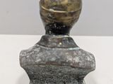 an image of a statue of a man with a gold ball on his head