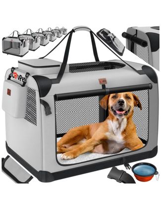 a dog that is sitting inside of a dog carrier