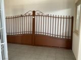a brown iron gate in a room with tile flooring