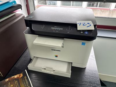 a printer that is sitting on a desk next to a book