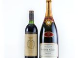two bottles of wine sitting next to each other on a white surface