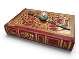 a red book with a clock on top of it