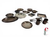 a lot of silver dishes and spoons on a white surface