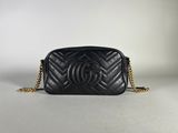 a chanel black quilted leather bag with gold chain strap