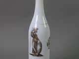 a white vase with a picture of a monkey on it