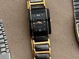 three watches are sitting on a table next to each other