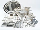 a lot of silverware on the table and silverware on the table