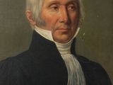 portrait of a man in a black coat with a white scarf