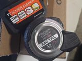 a close up of a watch with a box in the background